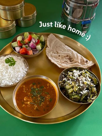Just like home. A simple, comforting meal of paneer bhurji, a dry vegetable dish, rice, salad, and roti.