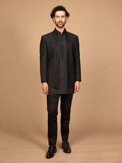 A full-length view of the black embroidered Bandhgala set. This outfit is a perfect fusion of tradition and modernity, designed to make a powerful statement.