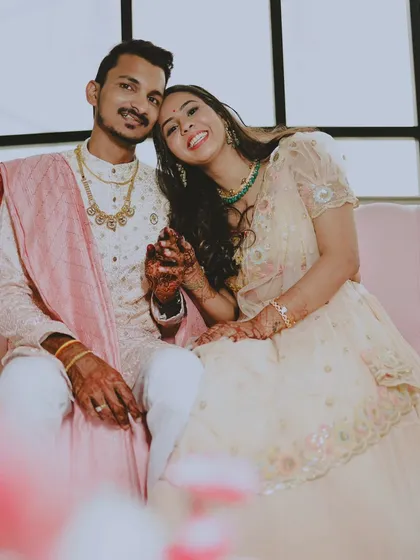 A sweet portrait of the engaged couple holding hands, with the bride leaning her head on the groom's shoulder.