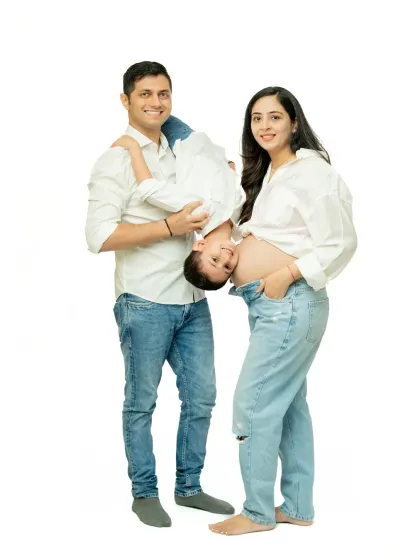 I love capturing playful, unposed moments like this. The father holding his son upside down brings genuine laughter and energy, showing the fun side of this growing family.