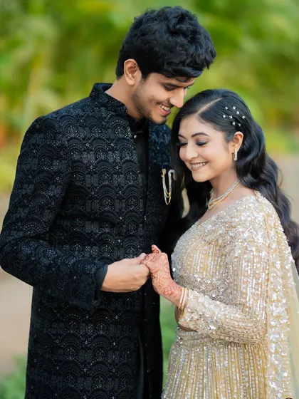 A tender moment captured between Apoorv and Shikha. The focus is on their hands and gentle smiles, highlighting their bond.