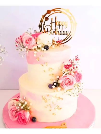 Celebrating the most special woman with an equally special cake. This two-tiered floral cake, adorned with fresh pink roses and baby's breath, is a beautiful and elegant way to say "Happy Birthday, Mom."