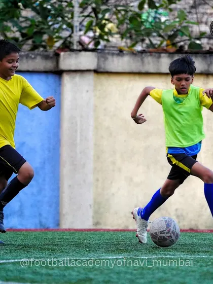 Players in different colored bibs during a practice match, learning about team shape and positioning.