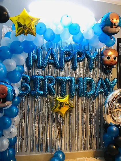 The Baby Boss theme is a fun choice for a little one's birthday. This decoration features a blue and white balloon backdrop, "Happy Birthday" letter foils, and multiple Baby Boss character balloons.
