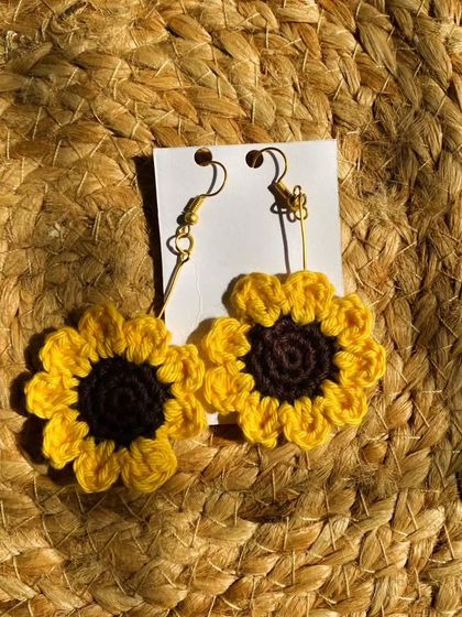 These crochet sunflower earrings are perfect for adding a pop of sunshine to your look. They are meticulously handcrafted to capture the cheerful look of a real sunflower.