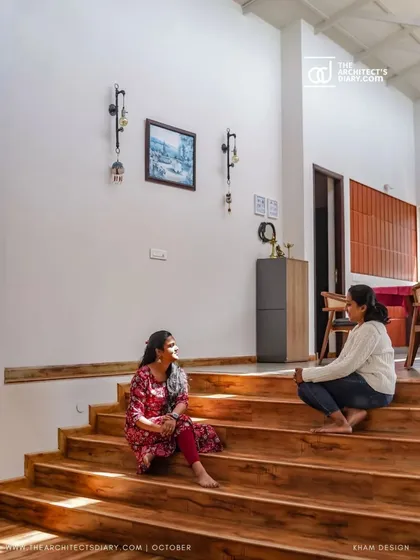 The wide wooden steps are more than just a staircase; they become an informal seating area, a place for conversation. This is an example of how I like to design multi-functional spaces that encourage interaction.