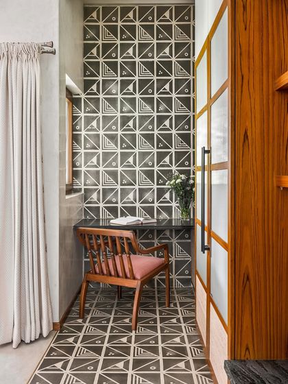 Even a small alcove can become a beautiful, functional space. This compact study nook is defined by bold, patterned tiles and a simple wooden desk, proving that good design doesn't require a lot of room.