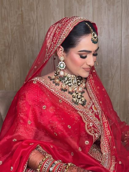 A side profile showcasing the elegant hair and makeup. The soft contouring and defined eyes create a beautiful, sculpted look that photographs perfectly.