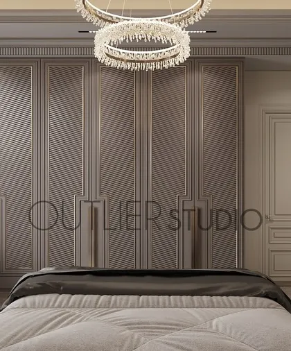This bedroom is a world of contrasts, with soft light and deep shadows. The design features classic wall mouldings and a full wall of wardrobes, creating a clean, uncluttered, and elegant look.