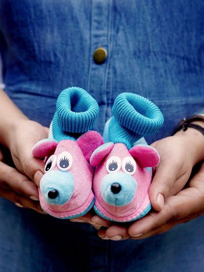 It's all about the little details. This shot of a couple holding tiny, adorable baby shoes is a creative way to announce your pregnancy and celebrate the new life you are waiting for.