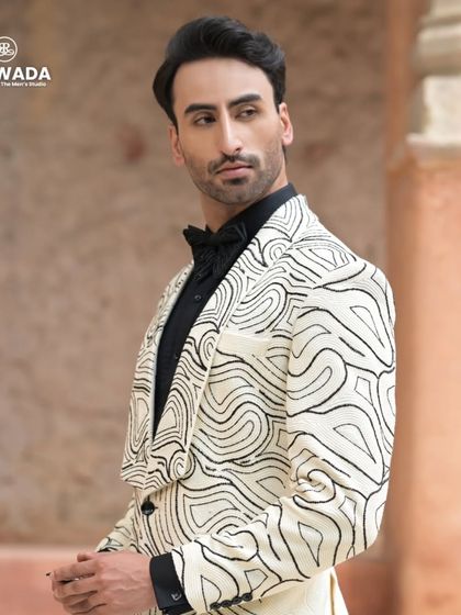A closer look at the abstract line-work tuxedo, showing the intricate sequin detailing and the sharp cut of the lapels.