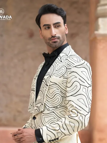 A closer look at the abstract line-work tuxedo, showing the intricate sequin detailing and the sharp cut of the lapels.
