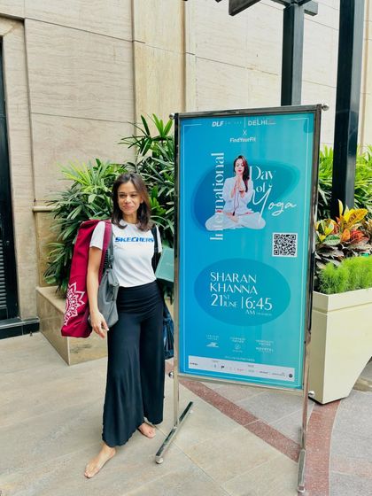A proud moment next to the poster for my International Yoga Day class. These large-scale events are a celebration of our community.