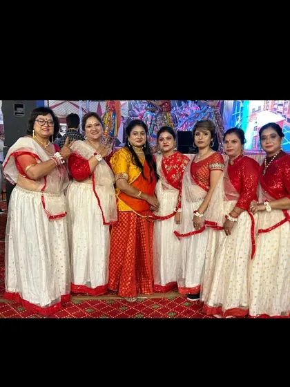 The final performance in full costume. We choreographed a vibrant Garba routine for this ladies' group, and seeing them light up the stage in their matching red and white outfits was a proud moment for our whole team.