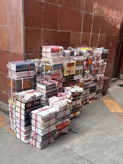 More stacks of books outside the law bookstore. Each bundle represents countless hours of research, argument, and judicial reasoning, the very foundation of our legal system.