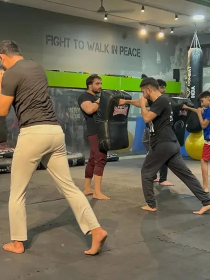 This is what a typical training session looks like. A room full of focused individuals, all working to sharpen their striking skills and improve their defensive capabilities.