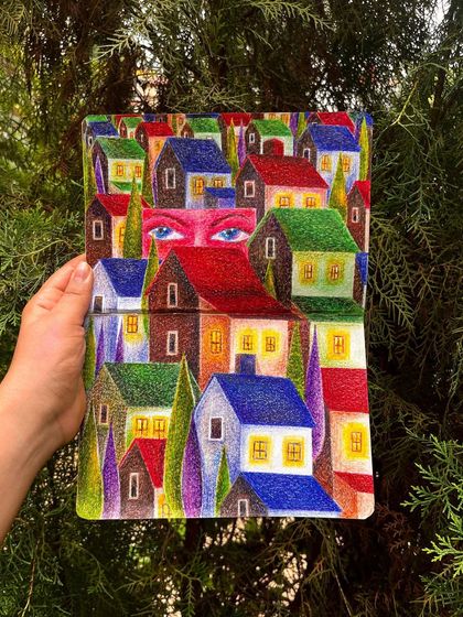 A colored pencil drawing of a mysterious neighborhood, with a giant pair of eyes peering out from behind the houses.