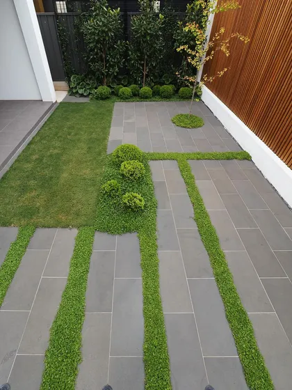 Attention to detail in hardscaping is one of our signatures. For this modern pathway, we used clean, rectangular stone pavers and planted low-maintenance ground cover in the gaps, creating a unique visual pattern that blends structured design with soft, natural elements.