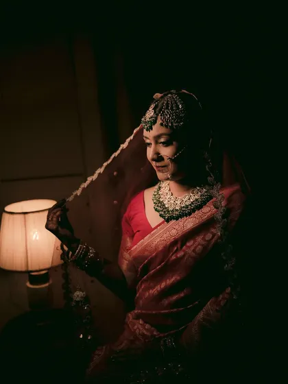 A classic bridal portrait using chiaroscuro lighting from a lampshade to create a dramatic, intimate, and timeless feel.