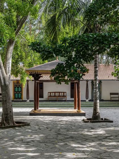 A wide view of one of our courtyards, framed by old-world pillars and traditional architecture, offering a spacious setting for guests to gather.