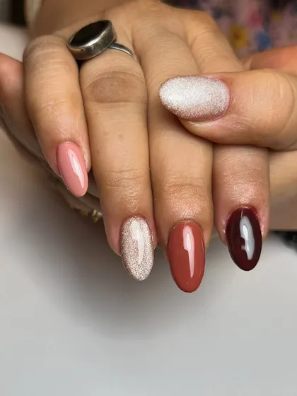 A sophisticated "skittles" manicure using different shades of brown and nude. This is a trendy way to wear solid colors, creating a cohesive yet interesting look.