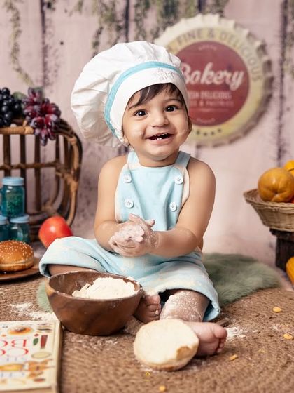 A happy chef with flour on his hands and a smile on his face. These messy, candid moments are what make themed photoshoots so authentic and memorable.