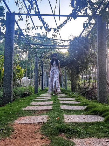 Walking through a beautiful garden pergola. Man-made structures that integrate with nature create lovely, inspiring spaces.