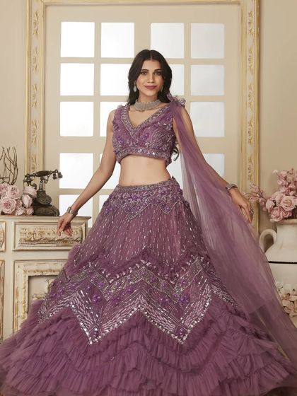 A full front view of the gorgeous lavender ruffled lehenga. The intricate silver embroidery and layered skirt make it a true showstopper for a Sangeet or reception.