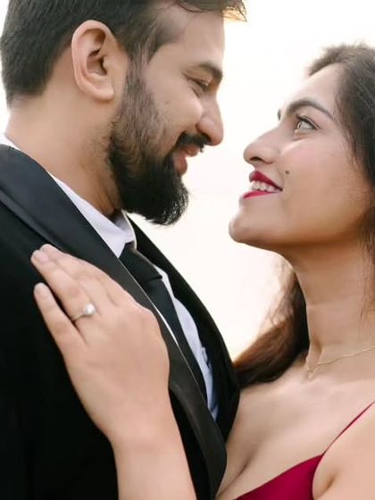 Her hand on his suit, their eyes locked. This close-up portrait is all about the chemistry and the story told in a single glance, showcasing the engagement ring as a beautiful detail.