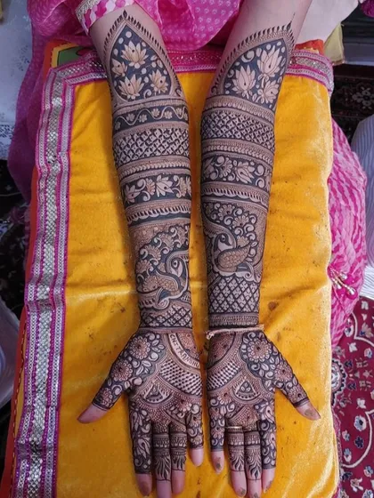 A full-arm design with bold peacock and lotus motifs, creating a striking look.