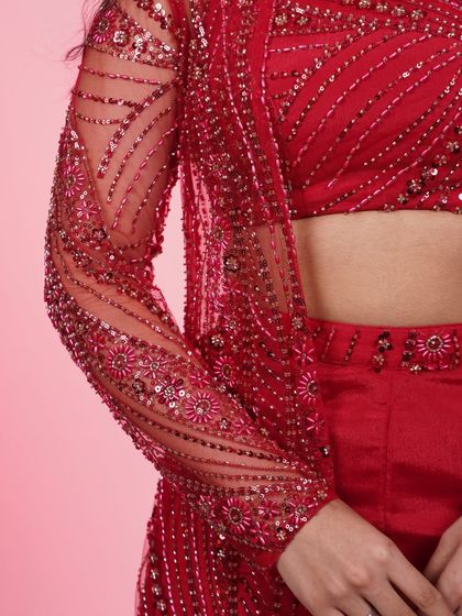 A close-up of the sleeve detail on our red three-piece Indo-Western set, showcasing the intricate floral beadwork.