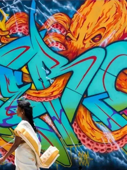 A piece from a graffiti jam in Nepal, where I mixed my wildstyle lettering with an octopus graphic. The contrast of a local woman walking past in a traditional sari captures the blend of global street art with local Indian life.