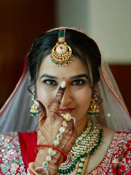 A playful and confident pose from the bride. Her bold eyes and flawless makeup make a striking statement.