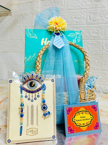 The final presentation of the Bhai-Bhabhi Rakhi hamper, with the evil eye rakhi set displayed prominently.