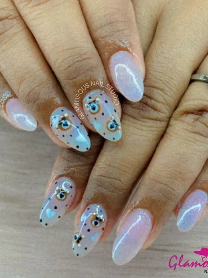 Ward off bad vibes with style. This unique set features a shimmery, iridescent base पुलिस with hand-painted evil eye designs and tiny black hearts. It's a look that is both trendy and meaningful.