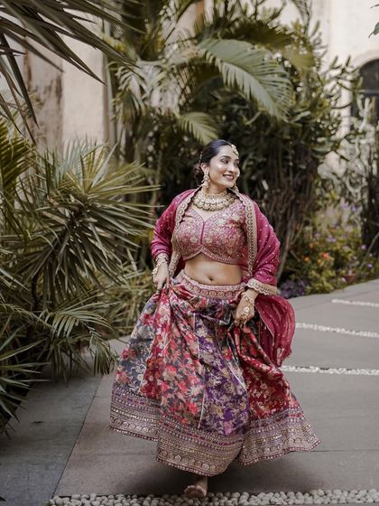 A candid shot of our floral lehenga, showing how beautifully it moves. The vibrant colors and lightweight fabric make it a comfortable and stylish option for pre-wedding festivities.