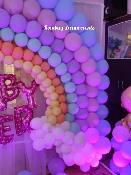 This view showcases the full rainbow balloon arch with a cute baby-shaped foil balloon. It's a wonderful way to add a lot of color and fun to a home baby shower celebration.