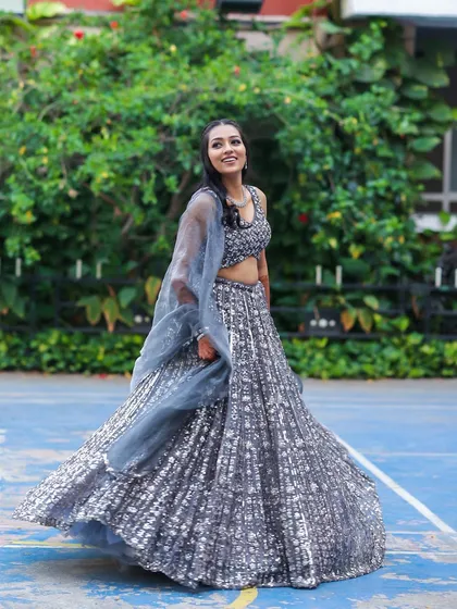A full-length shot of this sangeet bride, twirling in her shimmery grey lehenga.