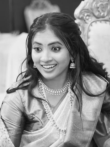 A bride's surprised and delighted expression, captured in black and white.