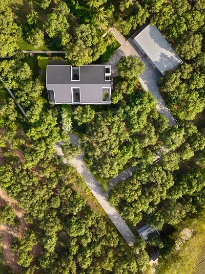 From above, the geometric layout of the house and its surrounding pathways becomes clear. The design is a thoughtful response to the site, creating a private residence that feels completely immersed in nature.
