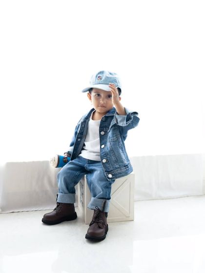 A stylish toddler posing in his denim-on-denim outfit. I love capturing the unique personality of every child.
