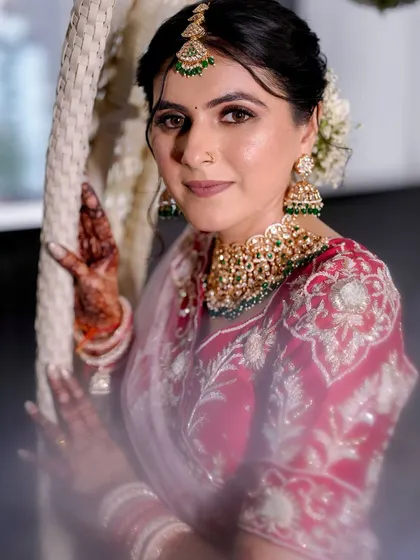 A beautiful portrait of our Gujarati bride. The makeup is subtle and elegant, allowing the intricate details of her red and white outfit to shine.