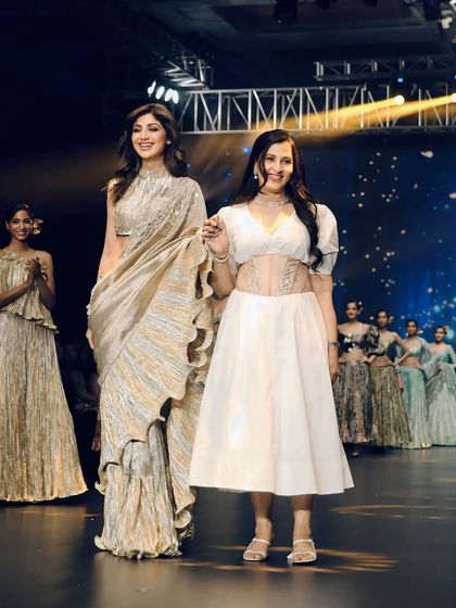 Shilpa Shetty with the designer on the ramp. This is a crucial shot for any fashion event, documenting the collaboration between the muse and the creator.