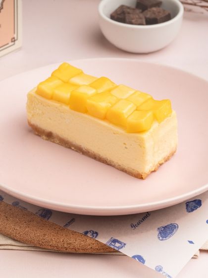 My Mango Cheesecake is a seasonal favorite. A creamy cheesecake base is topped with fresh, sweet mango cubes for a taste of summer.