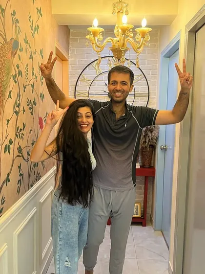 A photo of a joyful client couple in the hallway of their new home.
