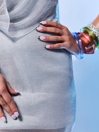 A detailed shot of the green chrome French tips on Shahana Goswami. You can see the flawless application and the beautiful shine of the chrome powder.