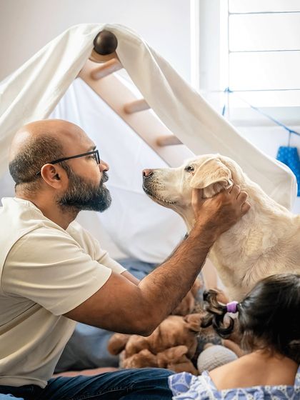 A tender moment between a father and his senior dog, Shelby. This quiet, loving interaction captures the deep connection they share, away from the family chaos.