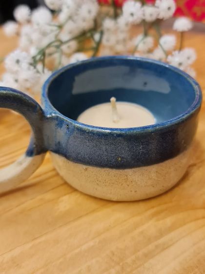 The tealight holder with a candle inside. It's a cute and charming piece, perfect for creating a warm ambiance. DM me to place an order.
