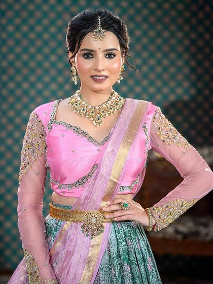 A classic portrait in the half-saree, showcasing the full beauty of the makeup and outfit.