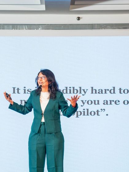 Speaking on stage. The quality of your life is determined by the quality of your questions. I help aspiring authors uncover their unique voice by asking the right questions.